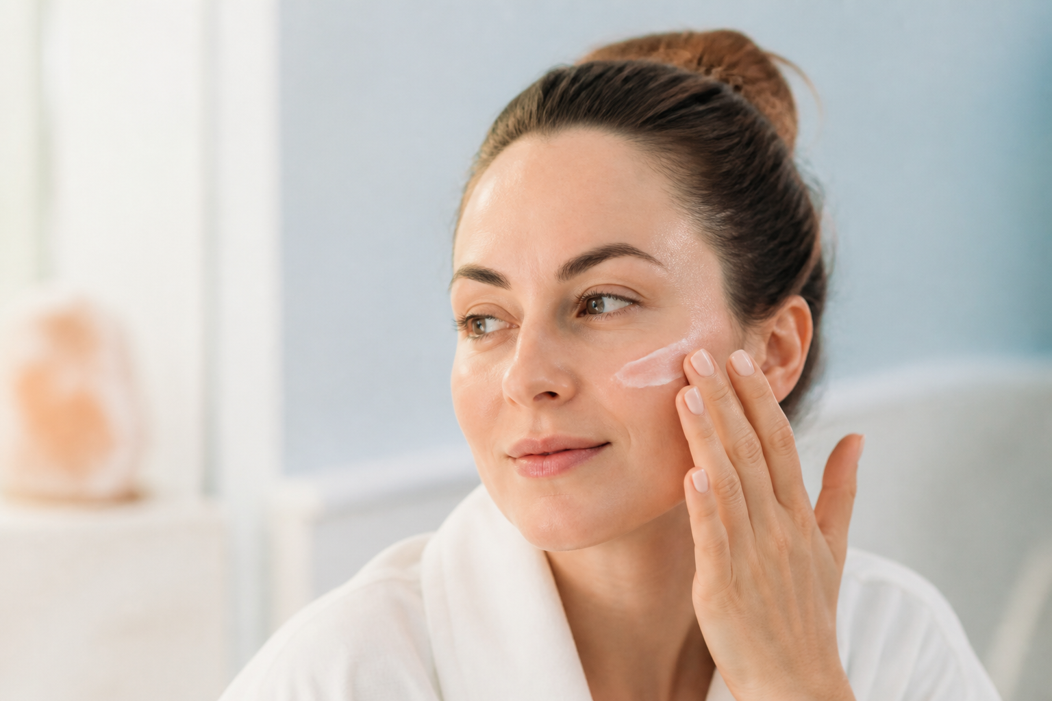 Woman protecting renewed skin with SPF after a chemical peel
